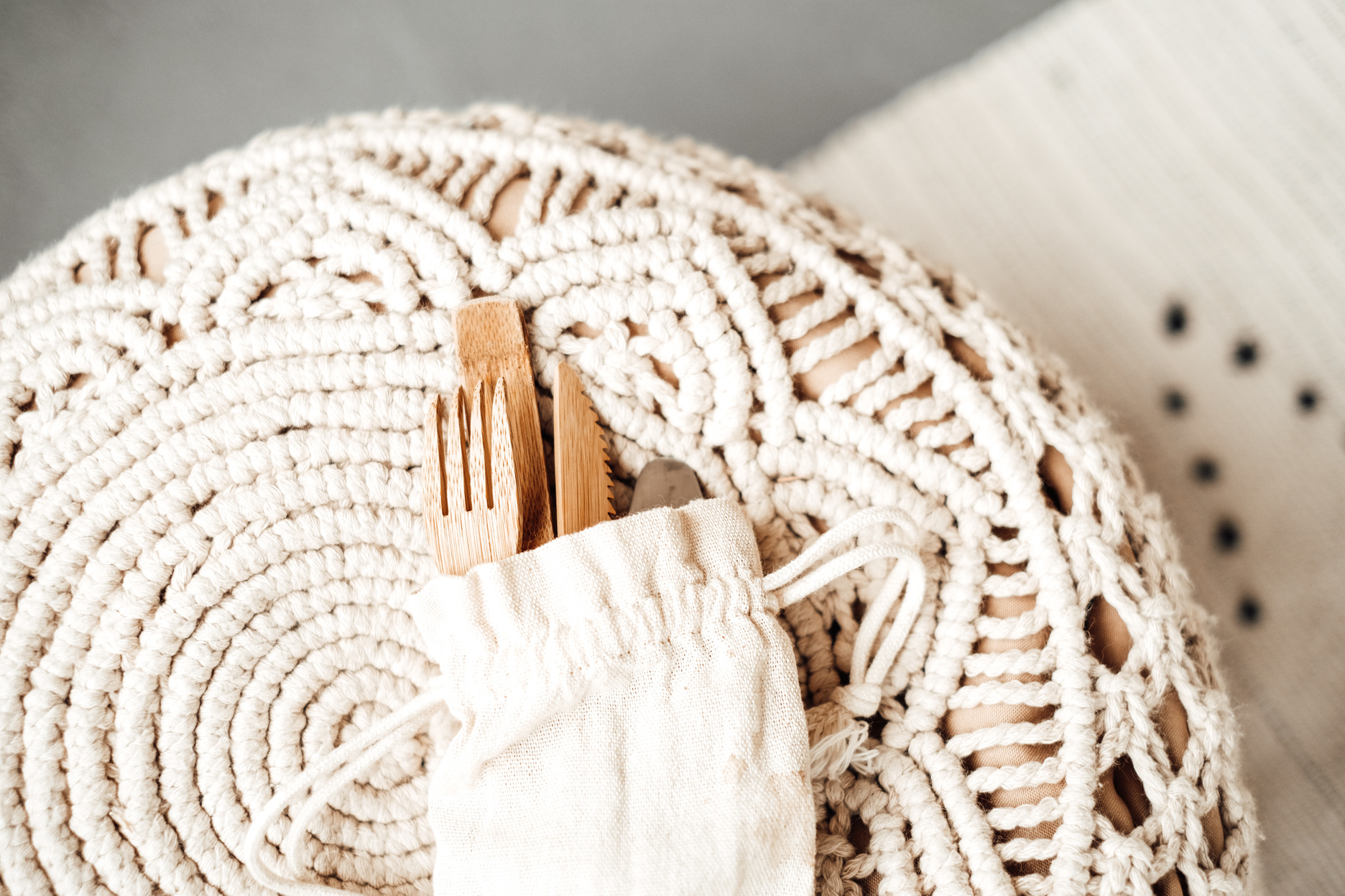 Wooden Utensils in Cloth Pouch on Macrame Tablecloth